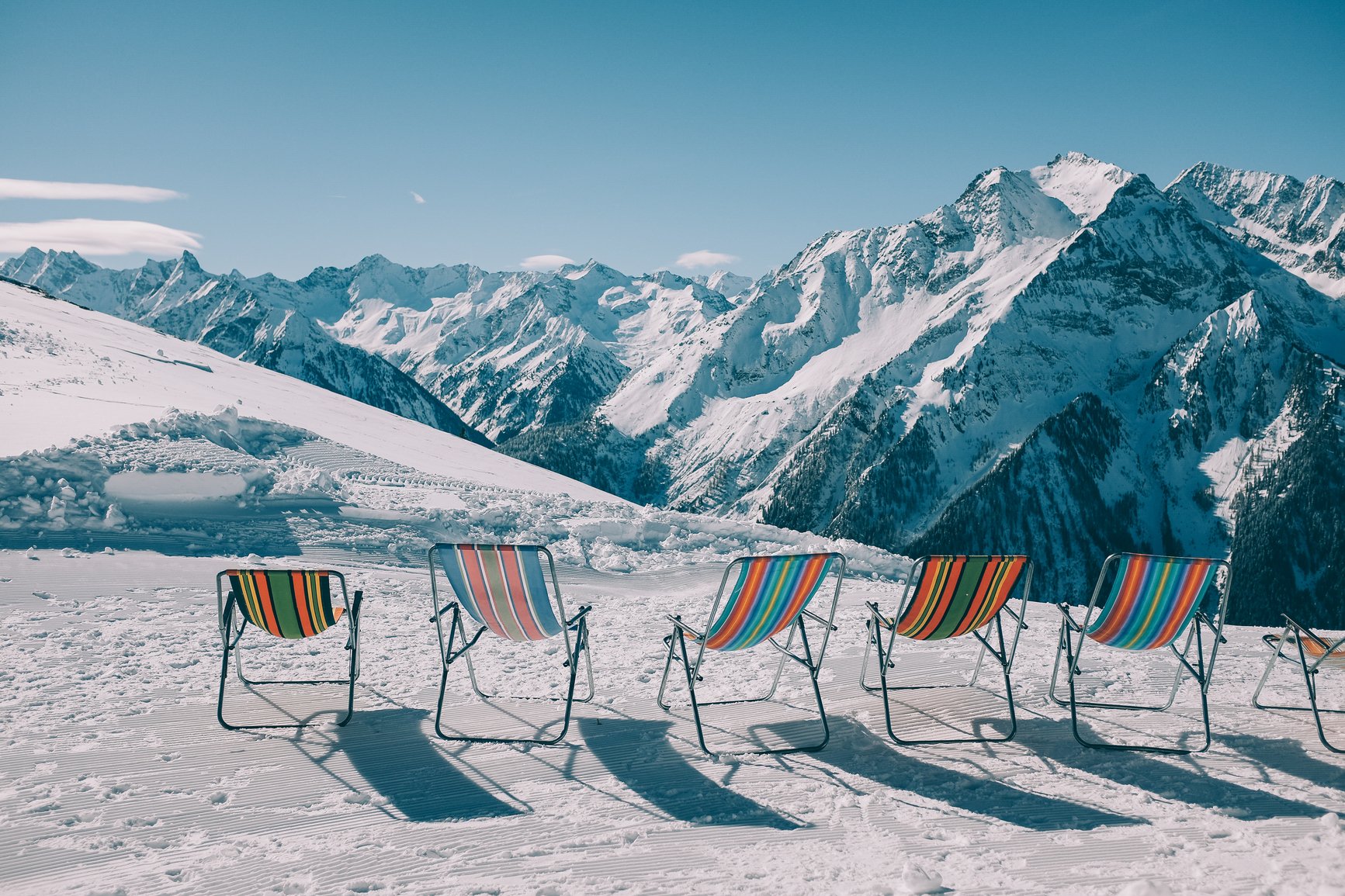 sun beds on ski snowy mountain